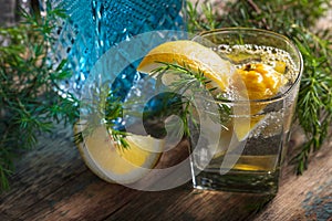 Cocktail with blue gin , tonic and lemon on a old wooden table