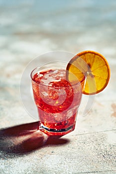 Cocktail boulevardier under sunlight with harsh shadows