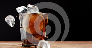 Cocktail with cola and limes slices isolated on black