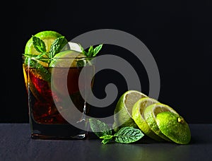 Cocktail Cuba libre with lime and peppermint leaves