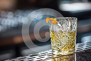 Cocktail drink old fashioned at barcounter in night club or restaurant