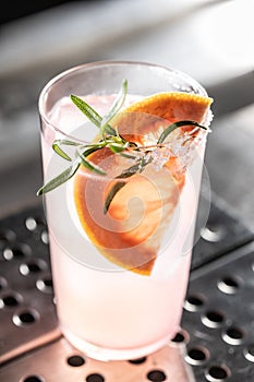 Cocktail drink Paloma with Gin grapefruit and soda decorated with rosemary
