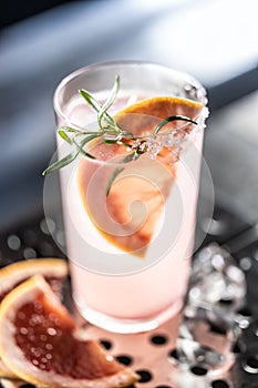 Cocktail drink Paloma with Gin grapefruit and soda decorated with rosemary