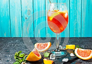 Cocktail drink on stone board. Alcoholic beverage with grapefruit and ice