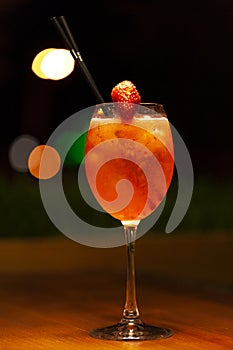 Cocktail drink with strawberry on the table on black background. Space in background for copy, text, your words