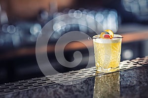 Cocktail drink whiskey sour at barcounter in night club or restaurant