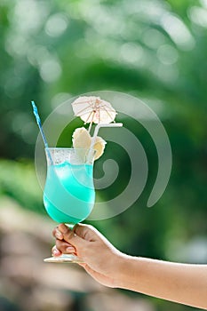 Cocktail drink in woman hand with copy space