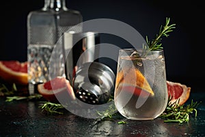 Cocktail gin tonic with ice, grapefruit, and rosemary