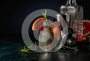 Cocktail gin tonic with ice, grapefruit, and rosemary