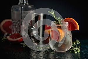 Cocktail gin tonic with ice, grapefruit, and rosemary