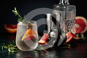 Cocktail gin tonic with ice, grapefruit, and rosemary