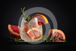 Cocktail gin tonic with ice, grapefruit, and rosemary