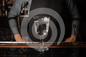 Cocktail glass filled with alcoholic drink on the bar counter