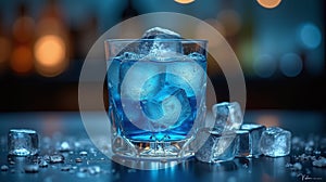Cocktail glass filled with blue liquid and ice cubes, set against a blurred background photo