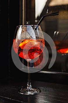 Cocktail glass with red drink on the wooden table