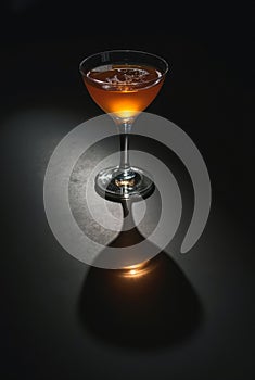 Cocktail Glass Shadow Ã¢â¬' Dramatic Low-Angle Light Casting Sharp Shadow on Dark Surface