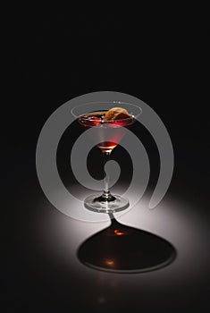Cocktail Glass Shadow Ã¢â¬' Dramatic Low-Angle Light Casting Sharp Shadow on Dark Surface