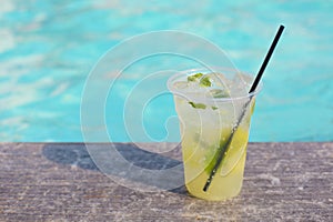 Cocktail glass on turquiose water background