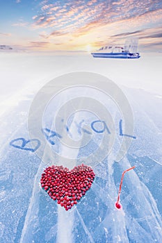 Cocktail kiss winter of lake Baikal with straw and hole in pure ice with cranberry heart