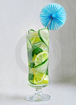 Cocktail of lemon cucumber and mint in a tall glass with decoration