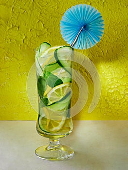 Cocktail of lemon cucumber and mint in a tall glass with decoration