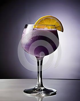 Cocktail with lemon and ice in a glass on a dark background.