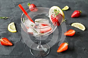 Cocktail made from Strawberries and rosemary ice cubes into the glass