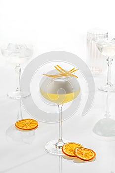 Cocktail mix in glass on white background with alcohol with orange peel foam Whiskey Sour