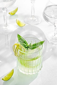 Cocktail mix mohito in glass on white background with lime, lemon, mint, soda,  alcohol, ice