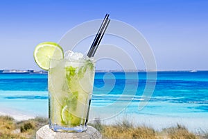 Cocktail mojito ice lemon straws in tropical beach