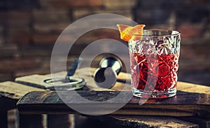 Cocktail Negroni on a old  wooden board. Drink with gin, campari martini rosso and orange