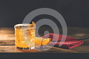 Cocktail Negroni on a old wooden board. Drink with gin, campari martini rosso and orange, an italian cocktail, an aperitif, first
