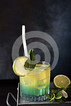 cocktail with orange juice and blue curacao liqueur in a glass