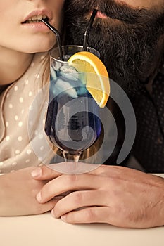 Cocktail party. Young couple drinking cocktail