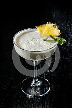 Cocktail Pina Collada. Garnished with a slice of pineapple and mint. photo