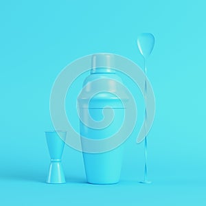 Cocktail shaker with jigger and mix spoon on bright blue background in pastel colors
