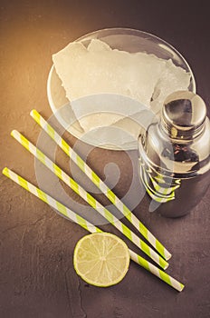 Cocktail shaker, lime, ice and straws/Cocktail shaker, lime, ice