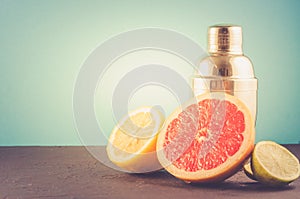 Cocktail shaker and tropical fruits on a blue background/Cocktail shaker and tropical fruits on a blue background. Selective