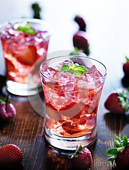 Cocktail with strawberries, ice, and mint