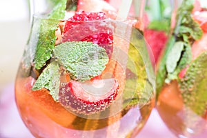Cocktail with strawberries, mint and bubbles.