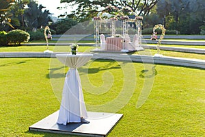 Cocktail table with wedding arch background