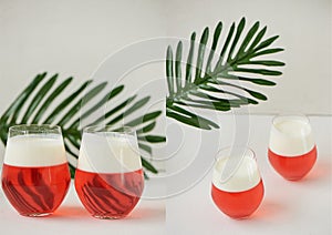 Cocktail in transparent glasses. Layers of jelly and whipped cream. Strawberry cocktail on a white background with a