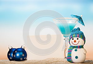 Cocktail with umbrella, snowman, blank card and Christmas balls