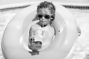 Cocktail on watter pool in the summer. Funny portrait of child. Kid having fun in swimming pool outdoors. Children with