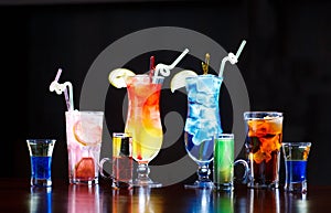 Cocktails on bar counter on black background