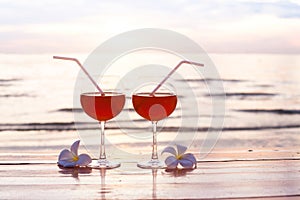 Cocktails on the beach at sunset, two glasses