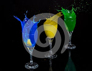cocktails drink with splash in the dark background