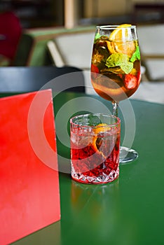 Cocktails with fruits and berries served on a table in restaurant or bar. Alcoholic beverage