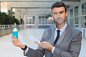 Cocky businessman holding a potion