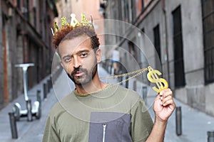 Cocky guy wearing crown and dollar-sign necklace photo